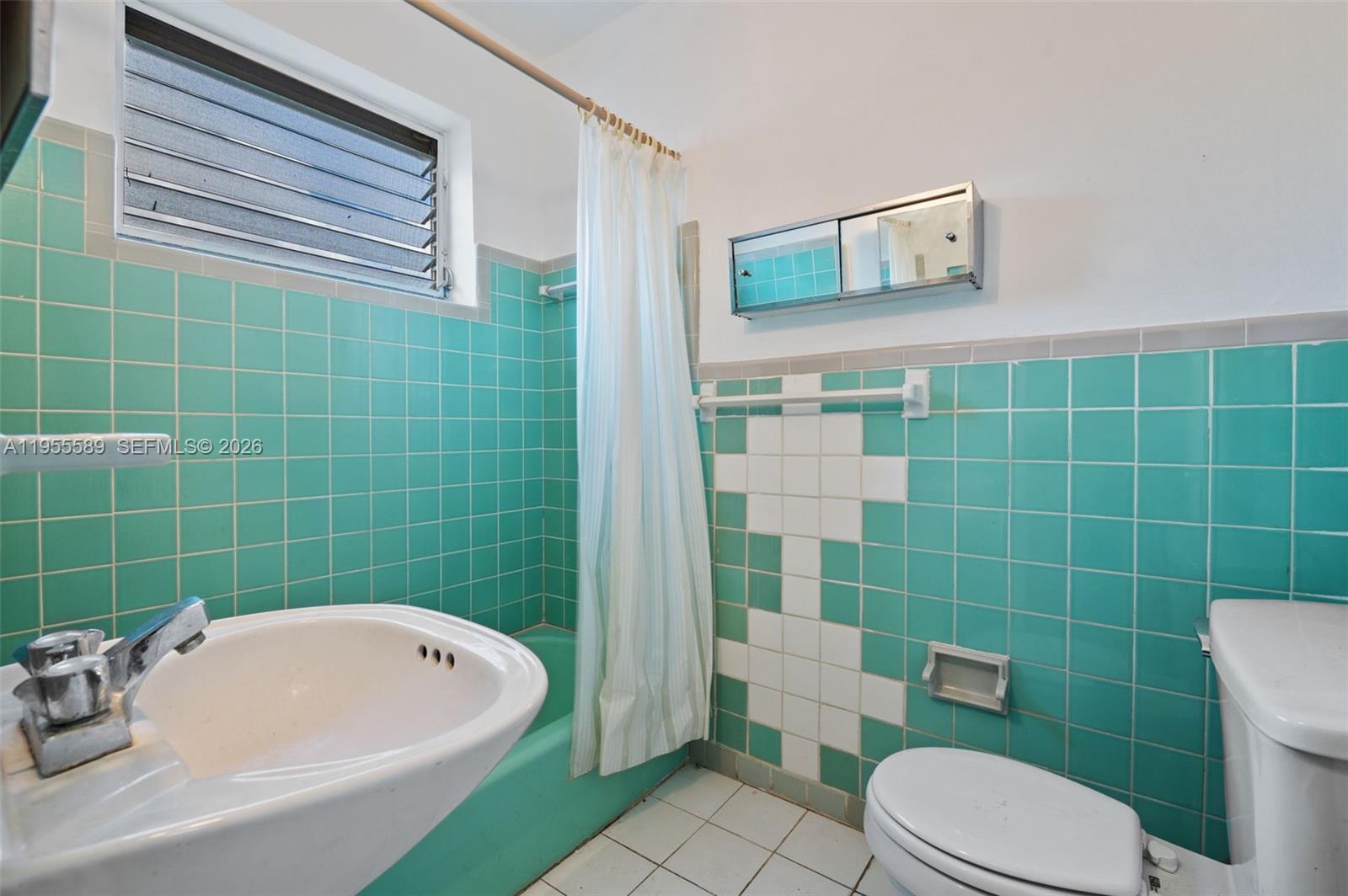 42 East 16th Street Hialeah, FL 33010 - Photo 14 of 30 a white bath tub sitting next to a white toilet