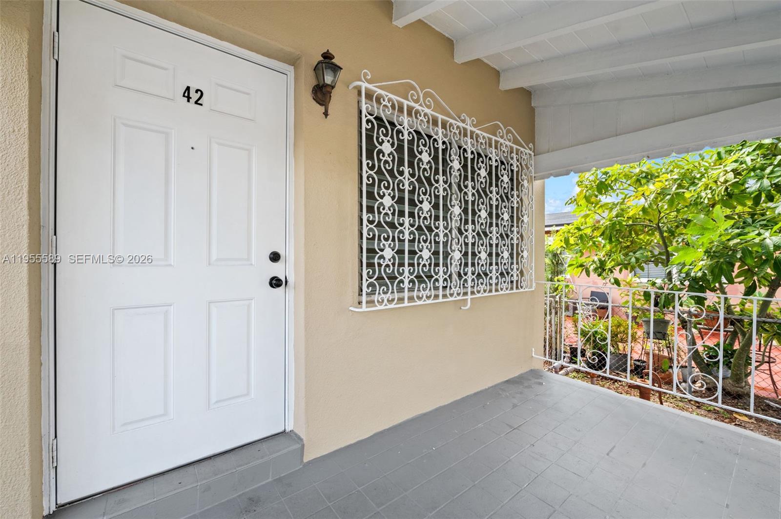42 East 16th Street Hialeah, FL 33010 - Photo 6 of 30 a view of entryway with a flower pot a table and a window
