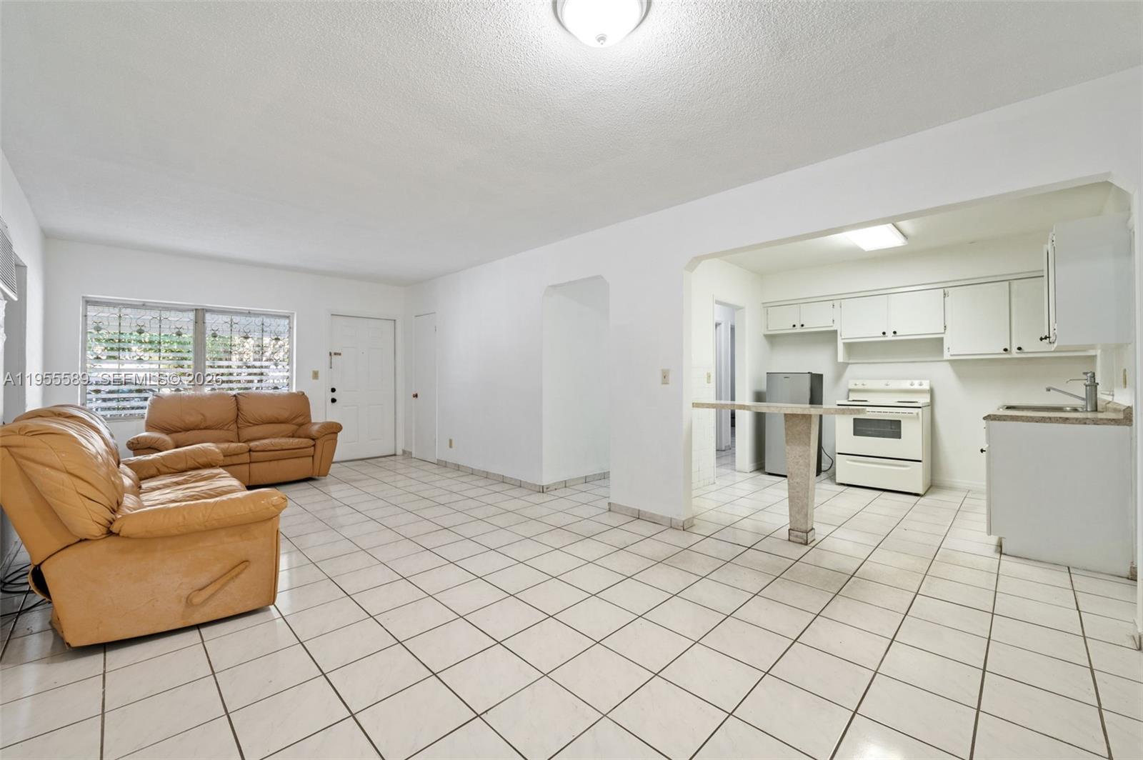 42 East 16th Street Hialeah, FL 33010 - Photo 8 of 30 a living room with furniture and kitchen view
