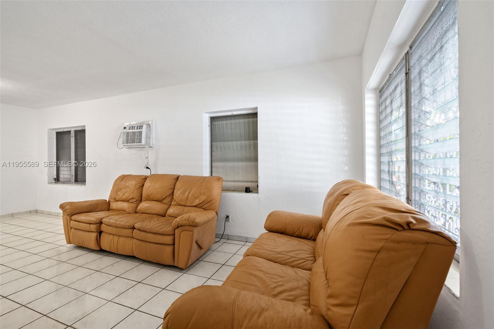 42 East 16th Street Hialeah, FL 33010 - Photo 10 of 30 a living room with furniture and a large window