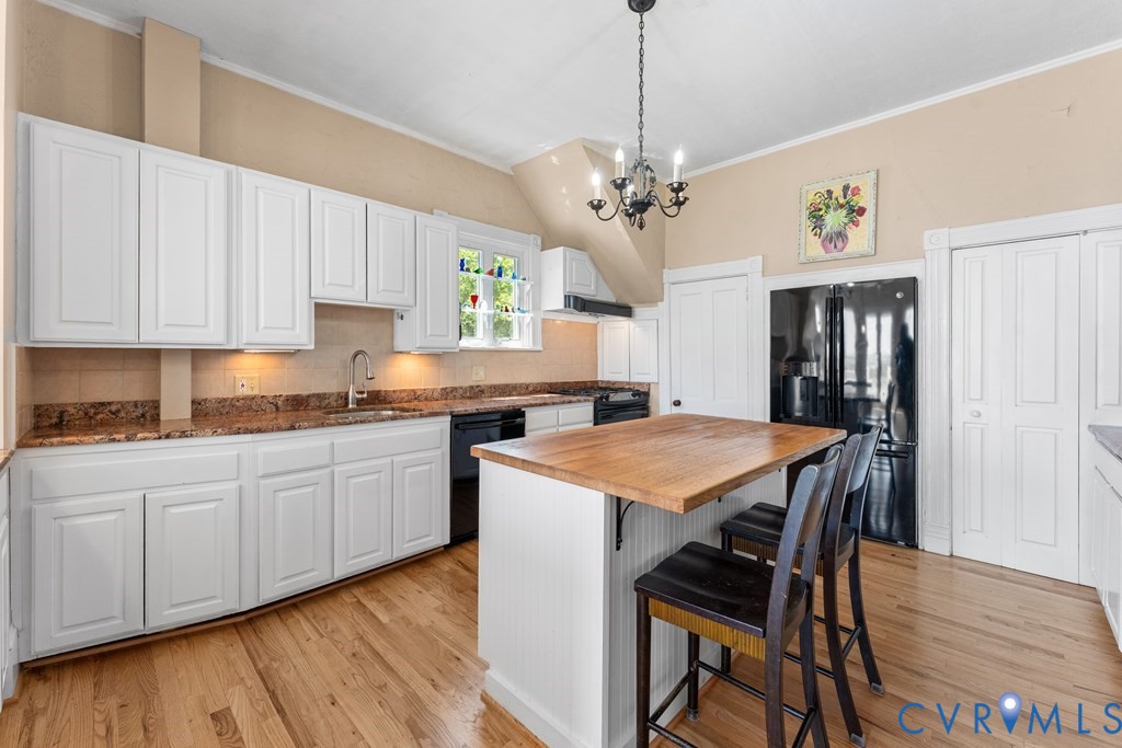 2414 Windmill Point Road White Stone, VA 22578 - Photo 18 of 72 a kitchen with stainless steel appliances granite countertop a kitchen island a stove a table and chairs in it