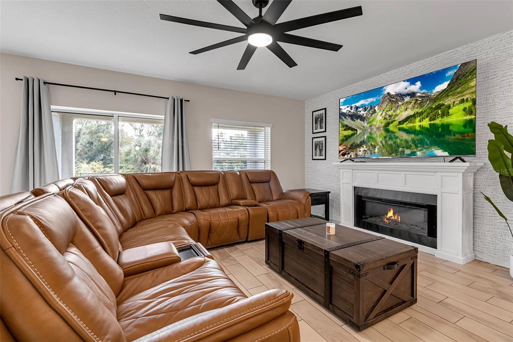 5434 Patano Loop Palmetto, FL 34221 - Photo 22 of 93 a living room with furniture a fireplace and a flat screen tv