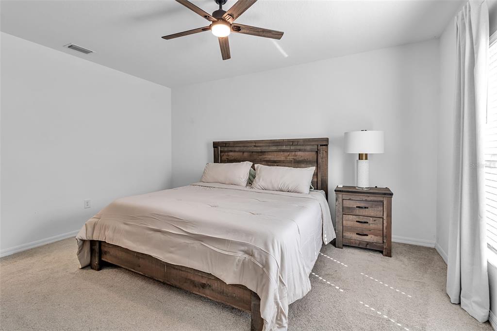 5434 Patano Loop Palmetto, FL 34221 - Photo 27 of 93 a bedroom with a bed and a cabinets