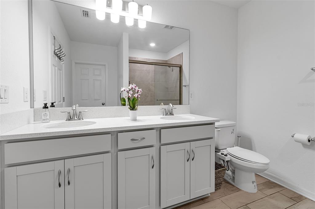 5434 Patano Loop Palmetto, FL 34221 - Photo 31 of 93 a bathroom with a toilet a sink a mirror and vanity