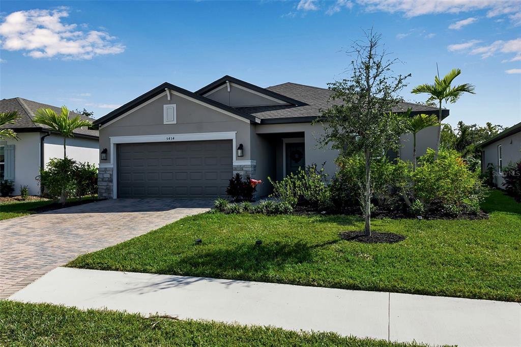 5434 Patano Loop Palmetto, FL 34221 - Photo 4 of 93 a front view of a house with a garden