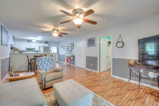 a living room with furniture and kitchen view