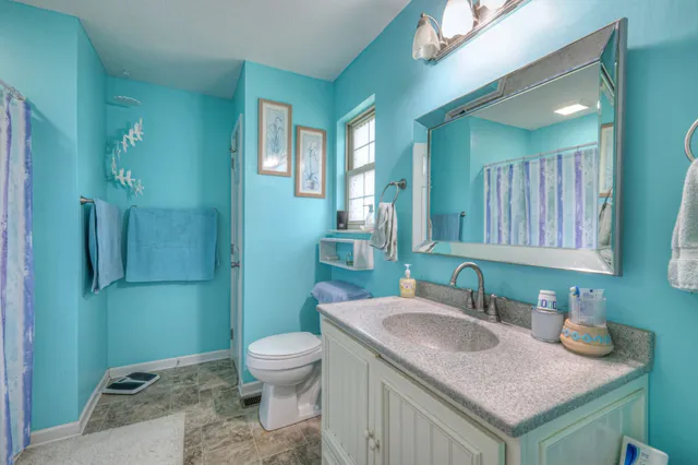 a balcony with chairs and wooden floor