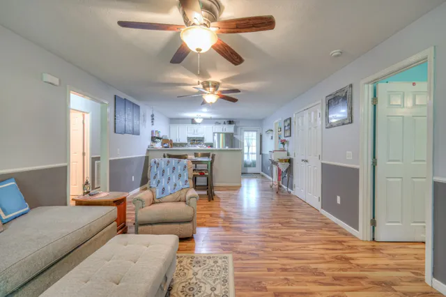 a living room with furniture and kitchen view