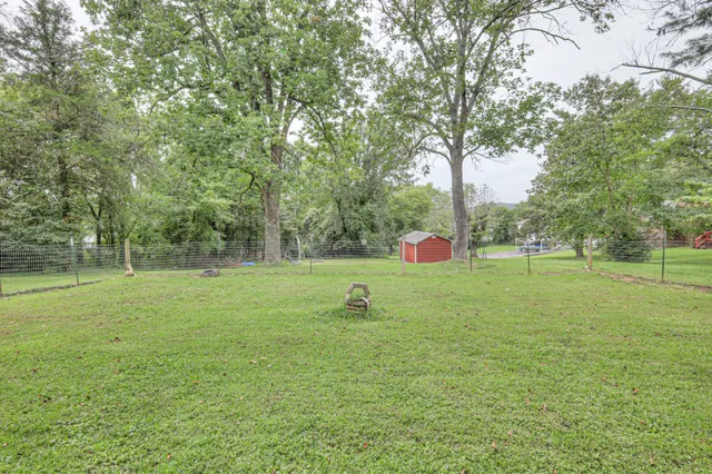 a view of a backyard with a fence