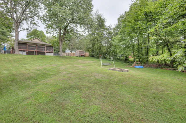 a view of a house with a backyard