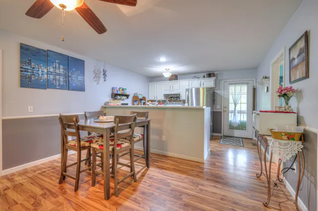 a view of a dining room with furniture and wooden floor