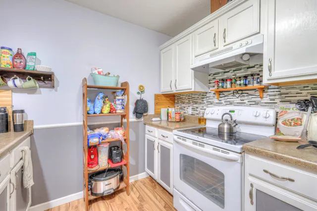 a kitchen with cabinets a sink and appliances