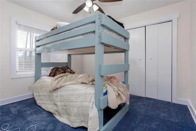 a bedroom with bed and a window