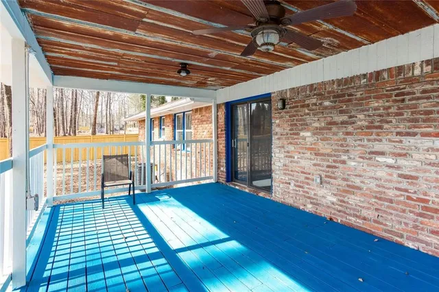 a view of porch with wooden floor