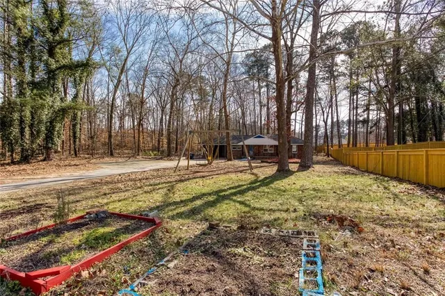 a view of backyard with a table and chairs