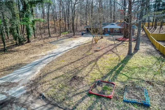 a view of a house with a yard and tree