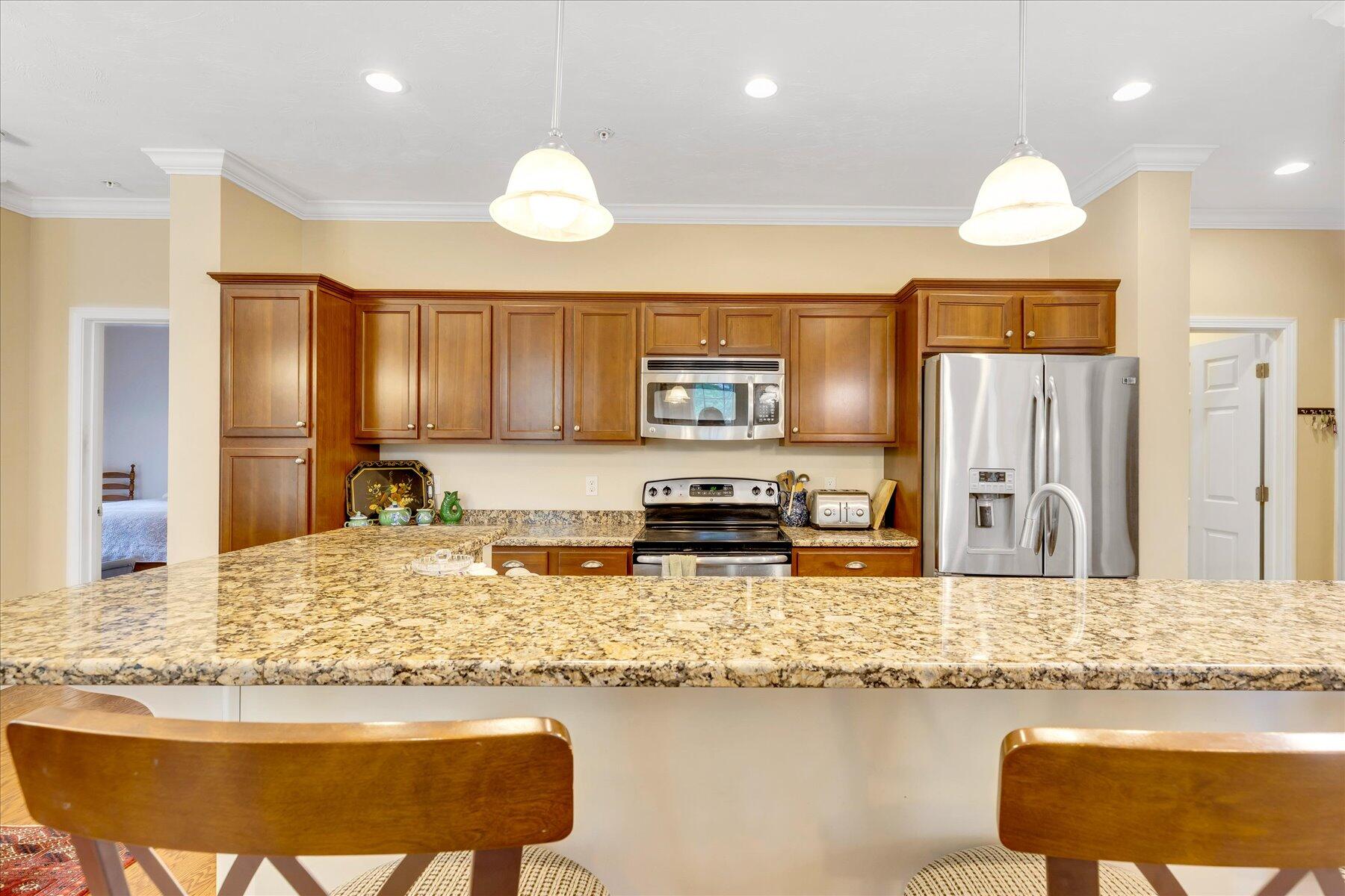 17 Chadwick Court Mashpee, MA 02649 - Photo 11 of 40 a kitchen with granite countertop sink and cabinets