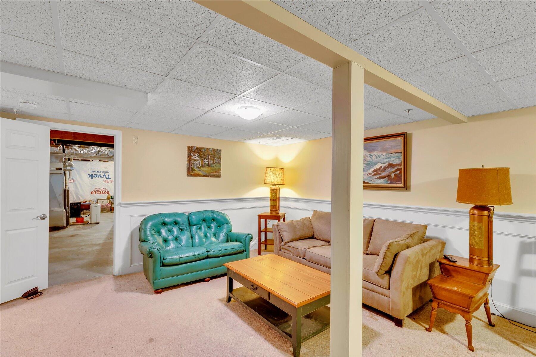 17 Chadwick Court Mashpee, MA 02649 - Photo 24 of 40 a living room with furniture and a lamp