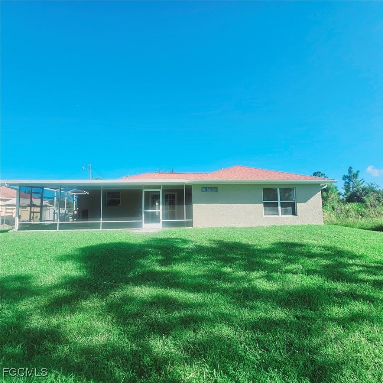 3780 Randall Boulevard Naples, FL 34120 - Photo 11 of 12 a front view of a house with a garden