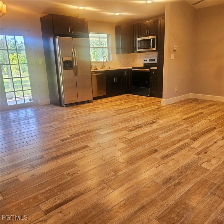 3780 Randall Boulevard Naples, FL 34120 - Photo 2 of 12 an empty room with kitchen view and appliances