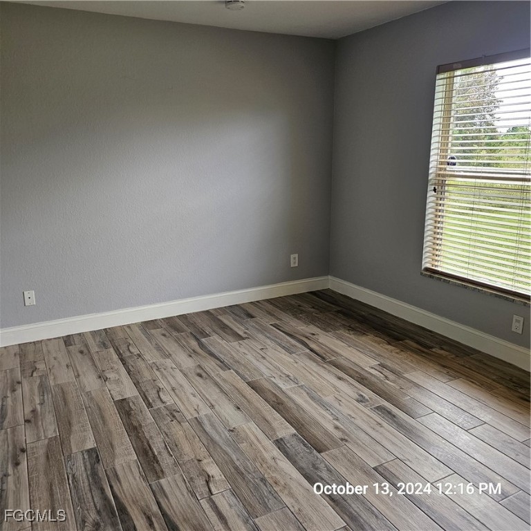 3780 Randall Boulevard Naples, FL 34120 - Photo 8 of 12 a view of a room with wooden floor and a window