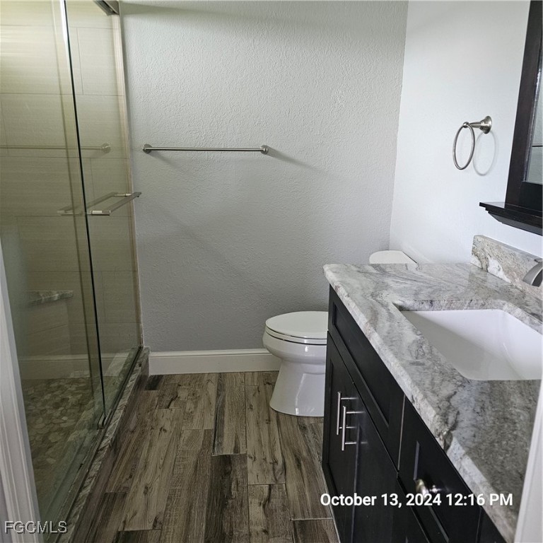 3780 Randall Boulevard Naples, FL 34120 - Photo 10 of 12 a bathroom with a granite countertop sink toilet and shower