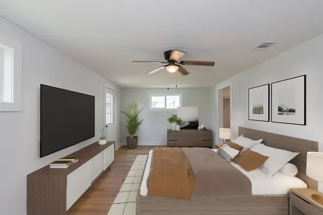 a bedroom with a bed and a flat screen tv