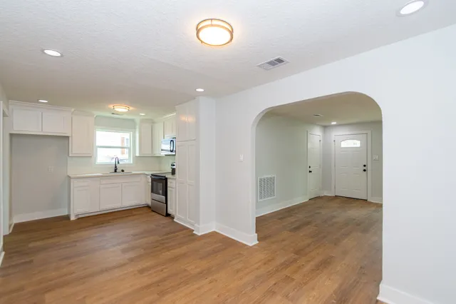 a large kitchen with a refrigerator and a stove top oven