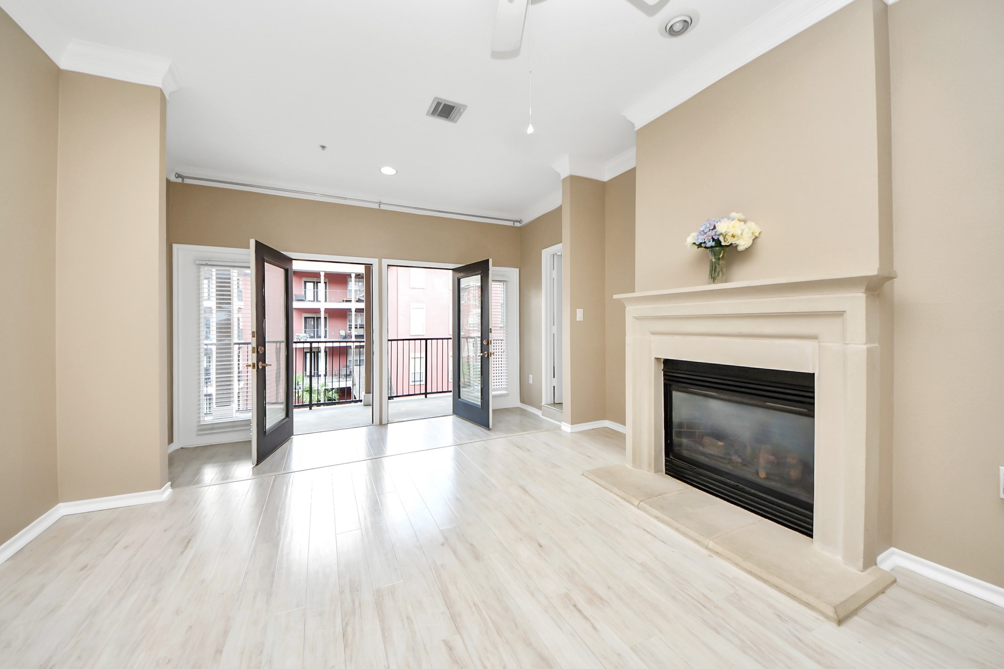 2400 McCue Road, Unit 333 Houston, TX 77056 - Photo 32 of 50 a view of an empty room with wooden floor fireplace and a window