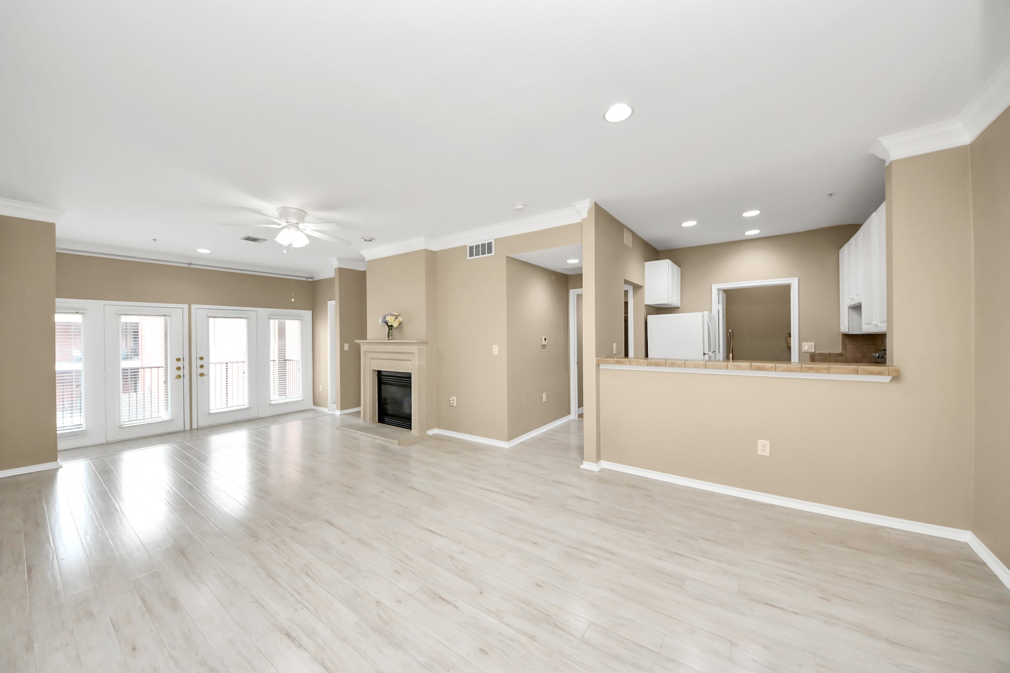 2400 McCue Road, Unit 333 Houston, TX 77056 - Photo 8 of 50 a view of an empty room with wooden floor and a kitchen