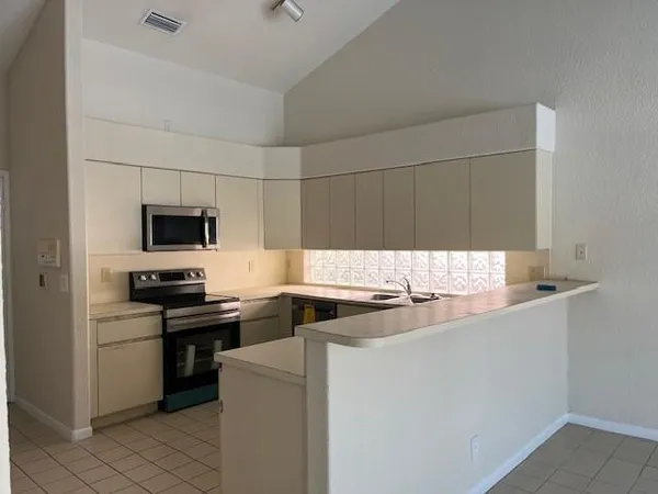 a kitchen with a sink and white cabinets