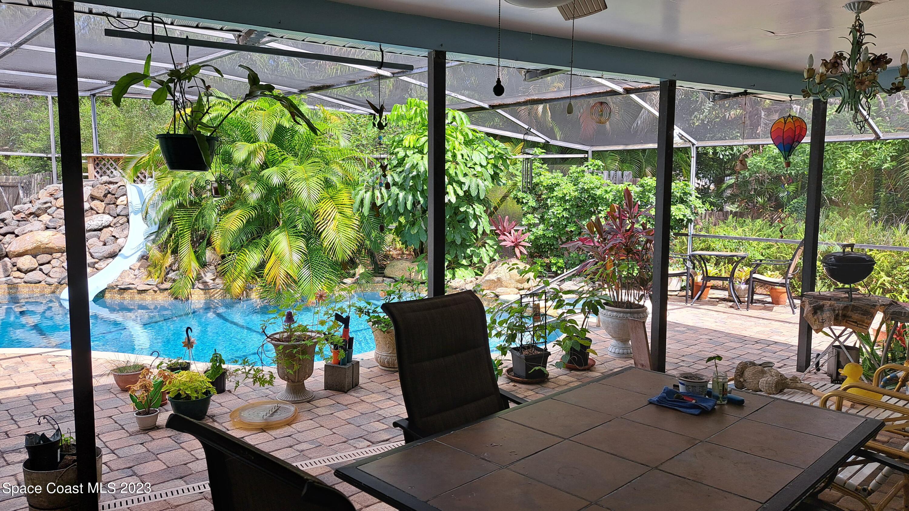 1083 Pineapple Avenue Northeast Palm Bay, FL 32905 - Photo 12 of 26 a backyard of a house with seating space