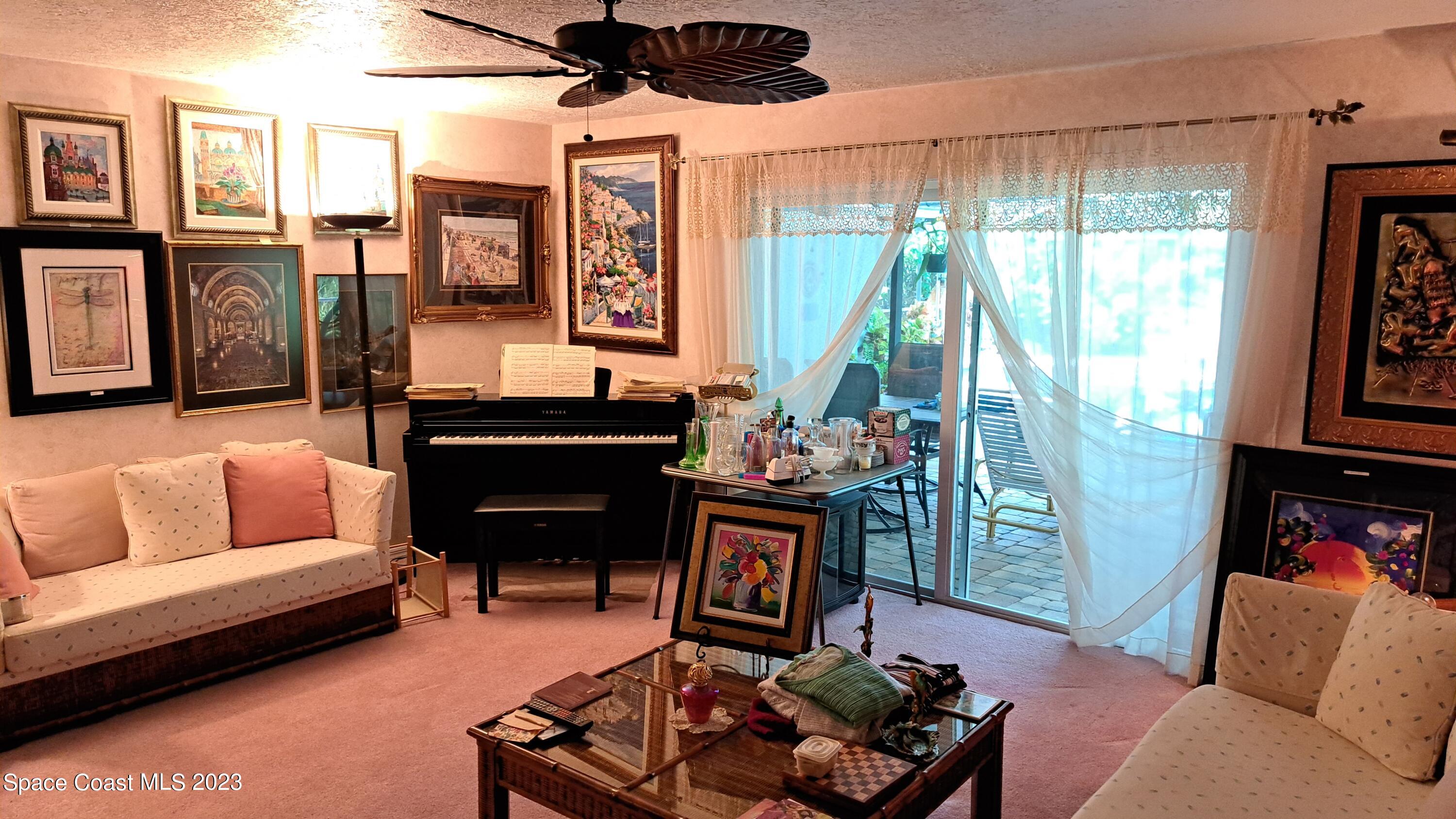 1083 Pineapple Avenue Northeast Palm Bay, FL 32905 - Photo 15 of 26 a living room with furniture and a fireplace