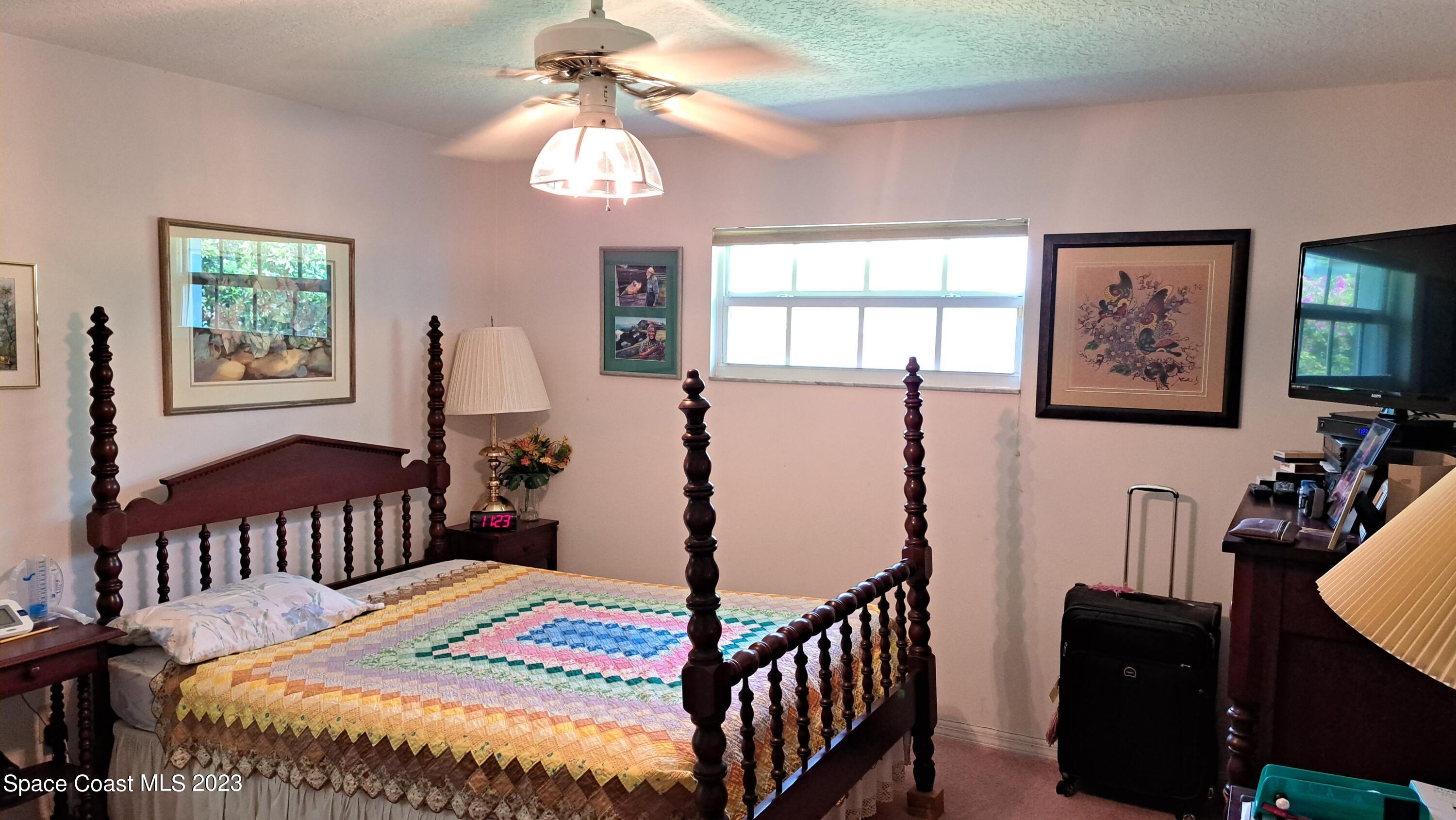 1083 Pineapple Avenue Northeast Palm Bay, FL 32905 - Photo 20 of 26 a bedroom with furniture and a window