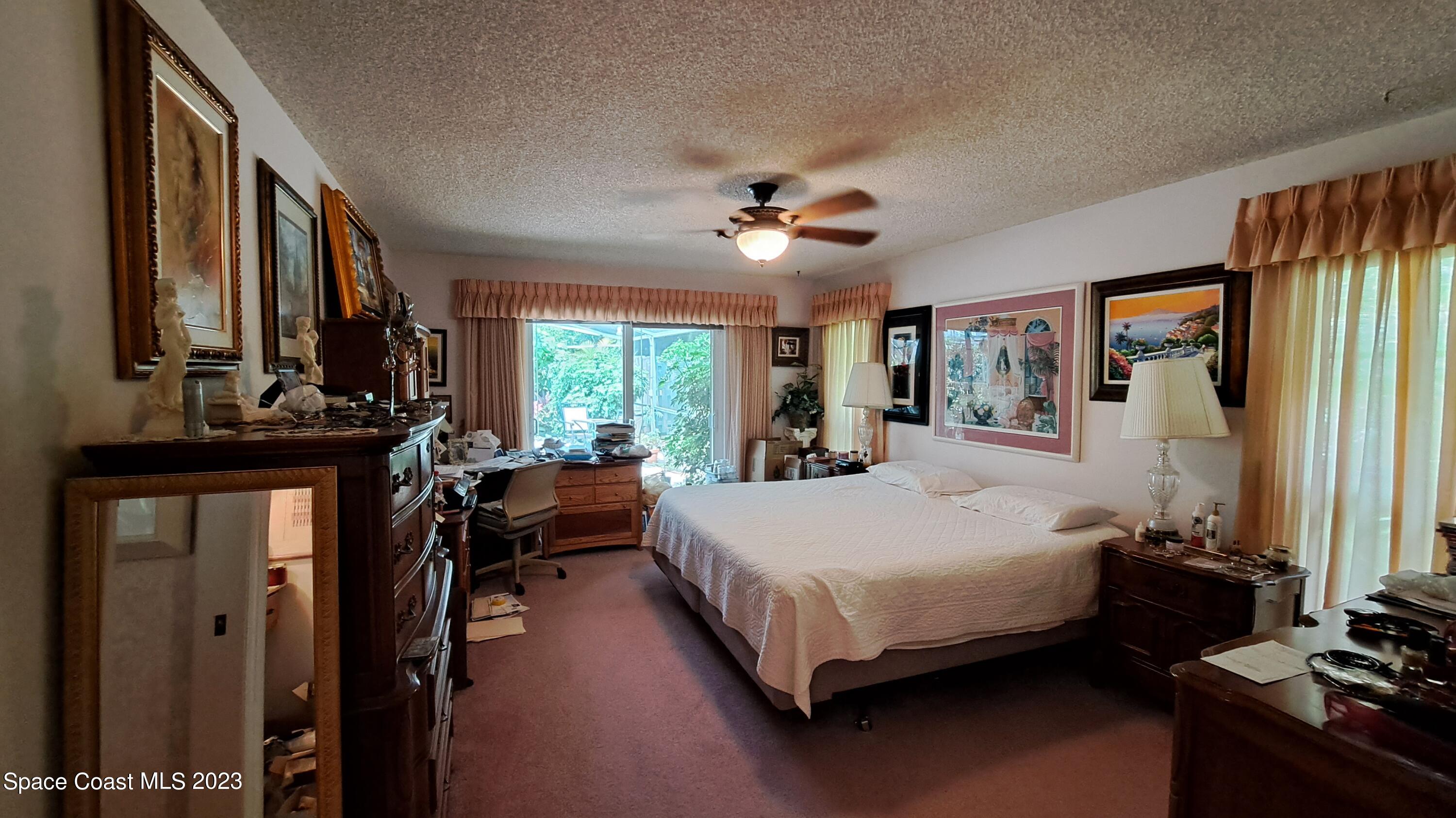 1083 Pineapple Avenue Northeast Palm Bay, FL 32905 - Photo 24 of 26 a bed room with a bed and a large window