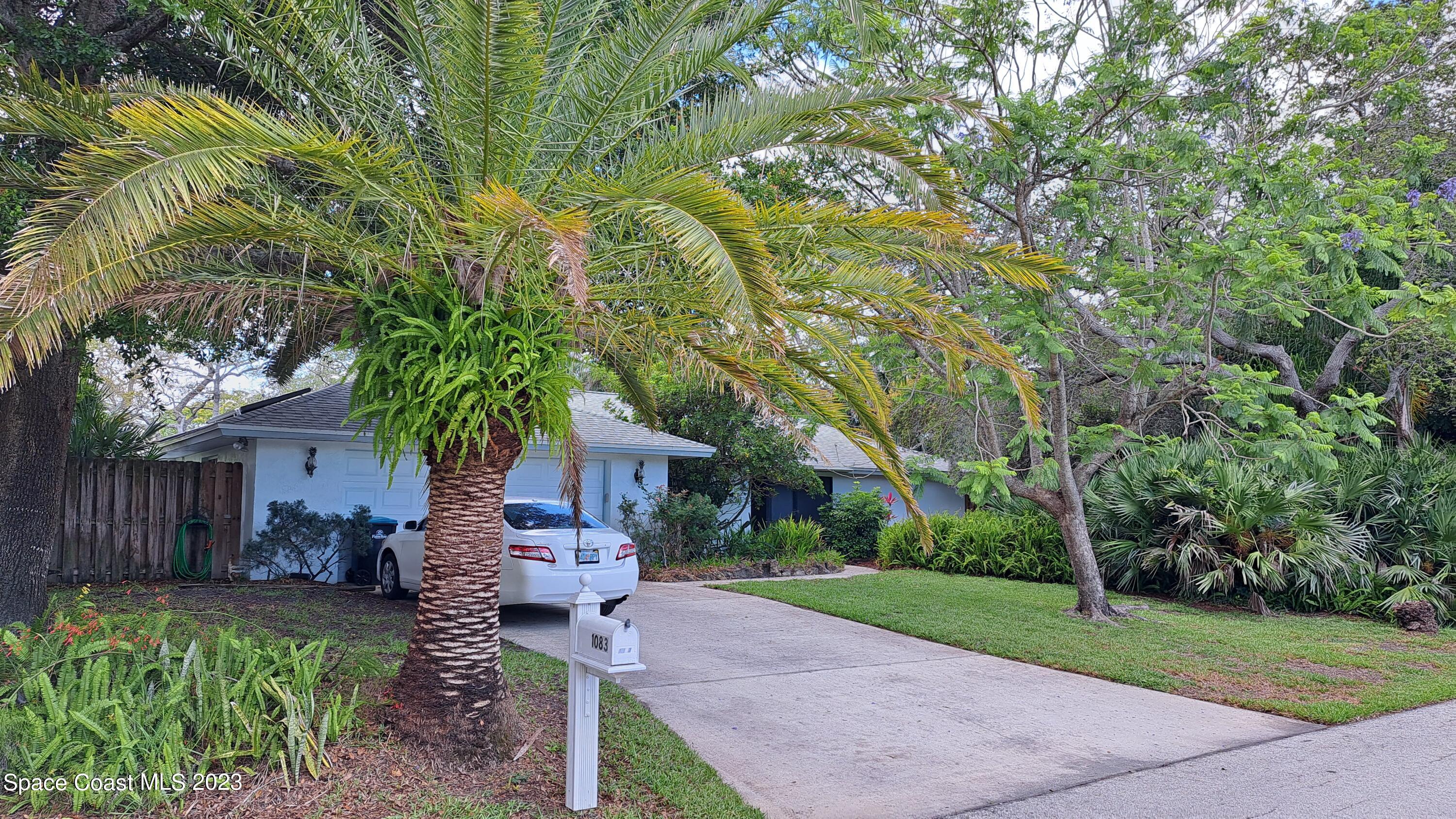 1083 Pineapple Avenue Northeast Palm Bay, FL 32905 - Photo 3 of 26 a front view of a house with garden