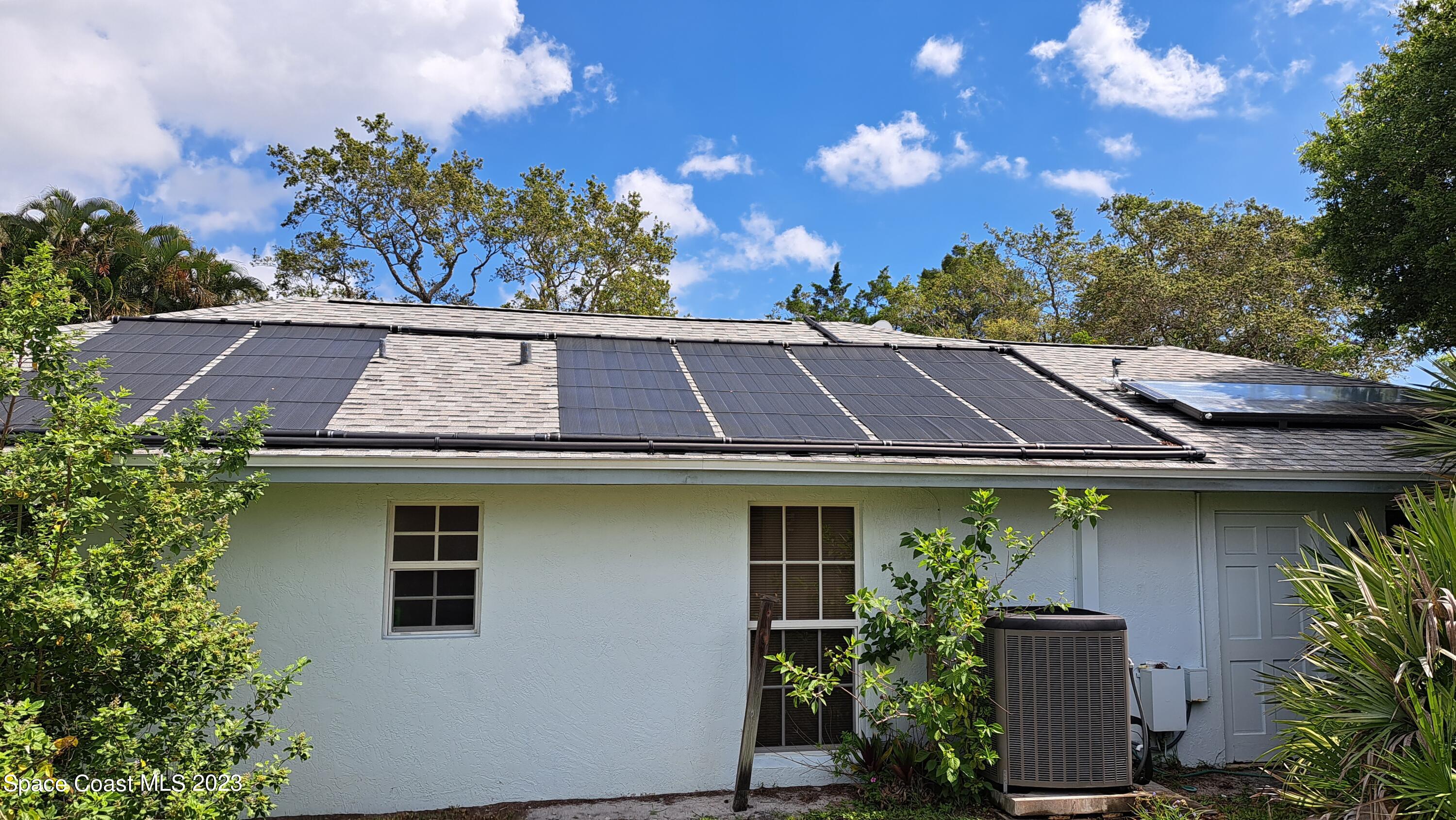1083 Pineapple Avenue Northeast Palm Bay, FL 32905 - Photo 9 of 26 a front view of a house with a garden