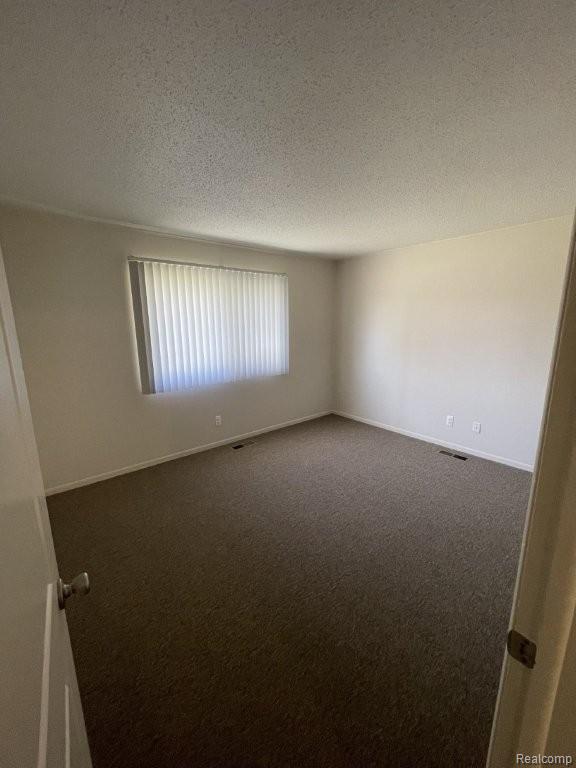35775 Union Lake Road Clinton Township, MI 48035 - Photo 25 of 30 Carpeted empty room featuring a textured ceiling and baseboards