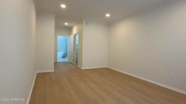 an empty room with an entrance to other room