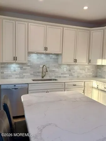 a kitchen with stainless steel appliances granite countertop a sink cabinets and granite counter tops
