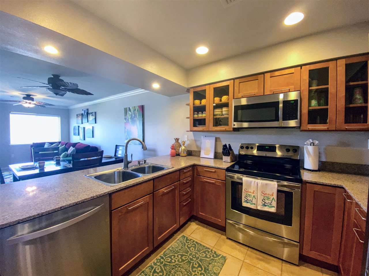 44 Kanani Road, Unit 2202 Kihei, HI 96753 - Photo 6 of 30 a kitchen with stainless steel appliances granite countertop a stove a sink and a microwave