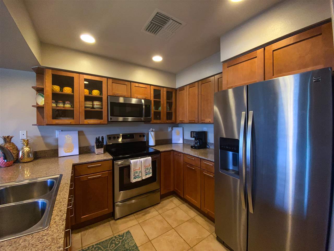 44 Kanani Road, Unit 2202 Kihei, HI 96753 - Photo 7 of 30 a kitchen with stainless steel appliances granite countertop a refrigerator stove and sink