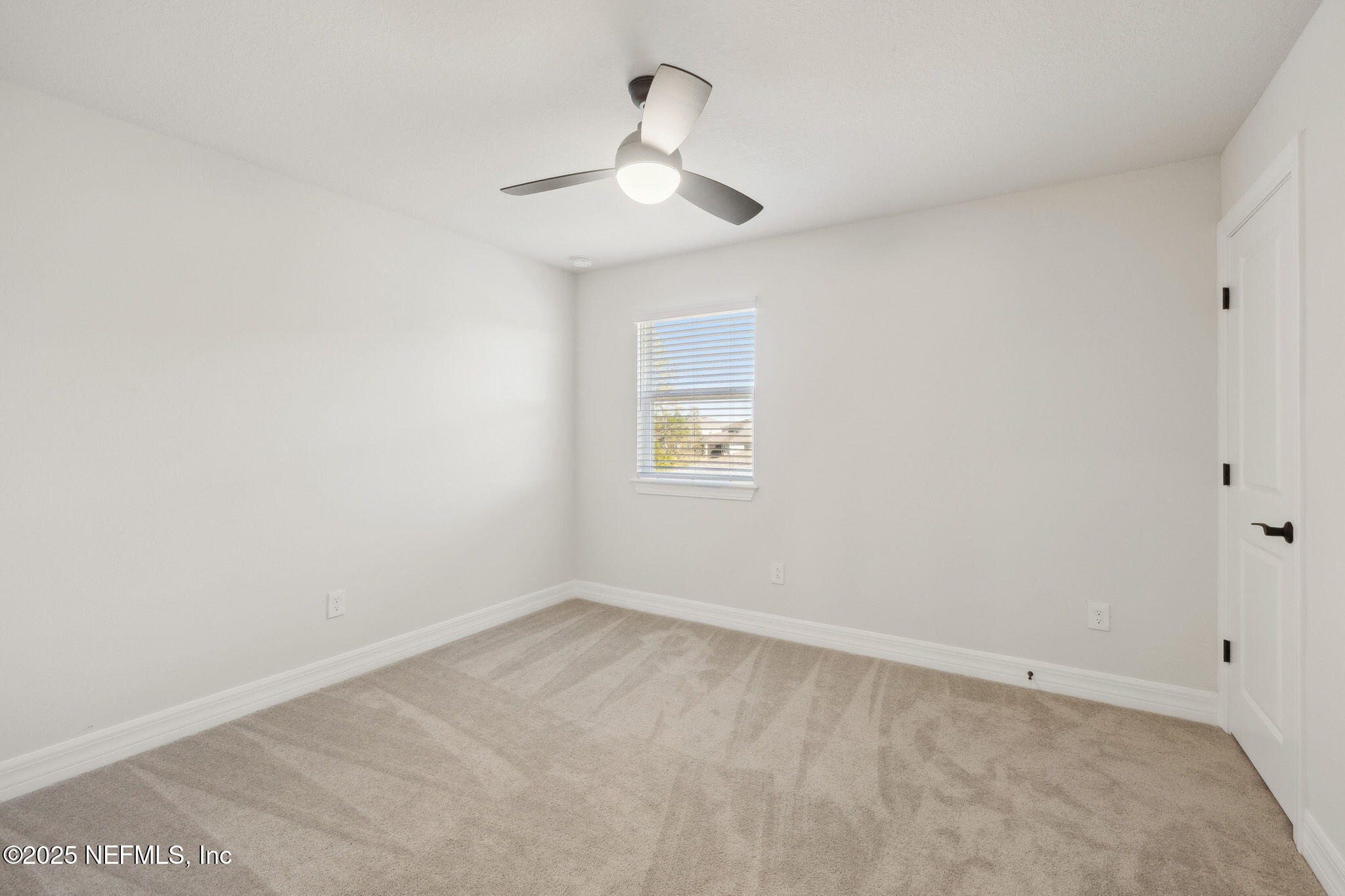 100 Red Barn Road St. Augustine, FL 32092 - Photo 43 of 86 an empty room with a chandelier fan and windows