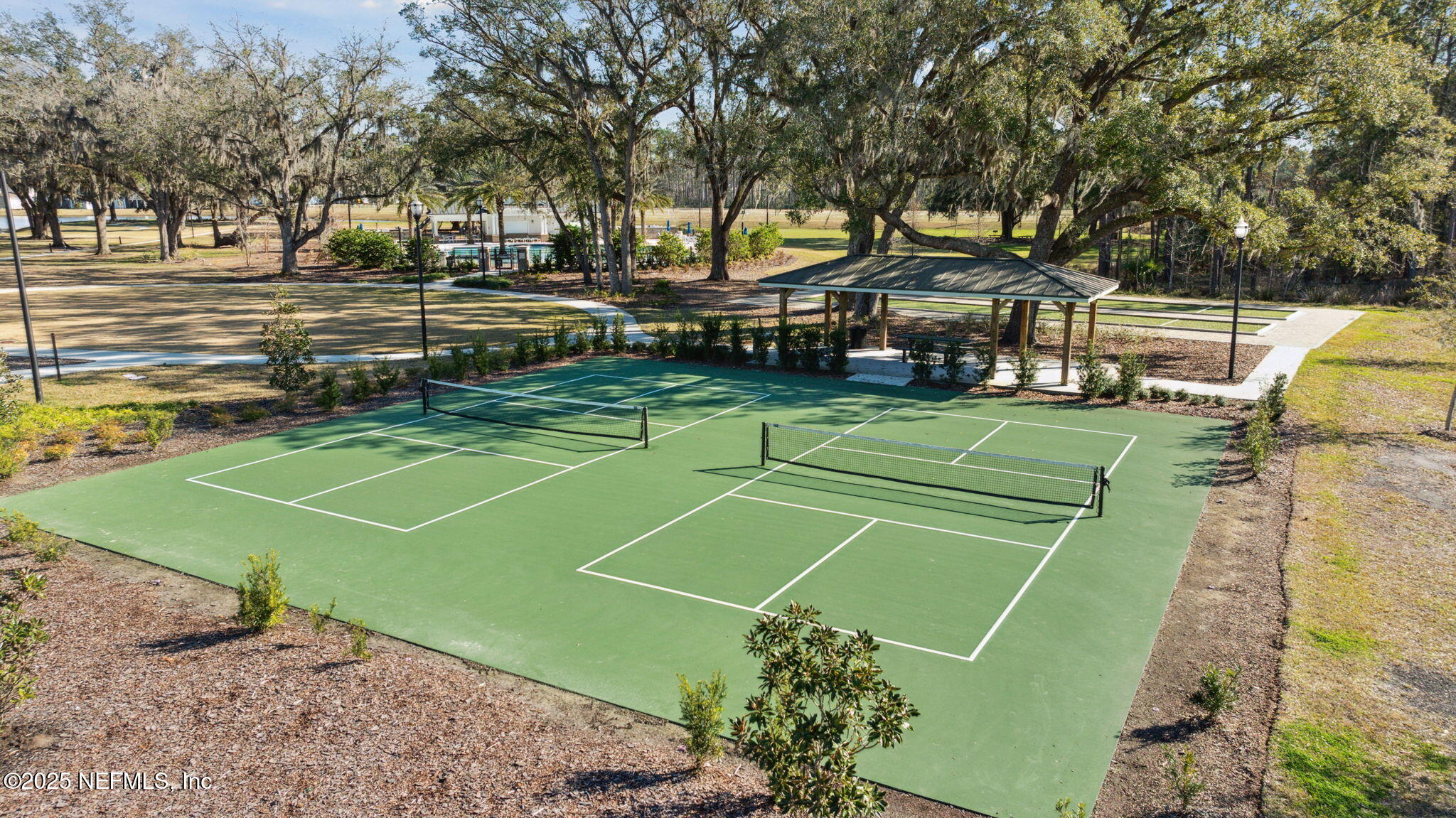 100 Red Barn Road St. Augustine, FL 32092 - Photo 58 of 86 a view of a tennis ground with large trees