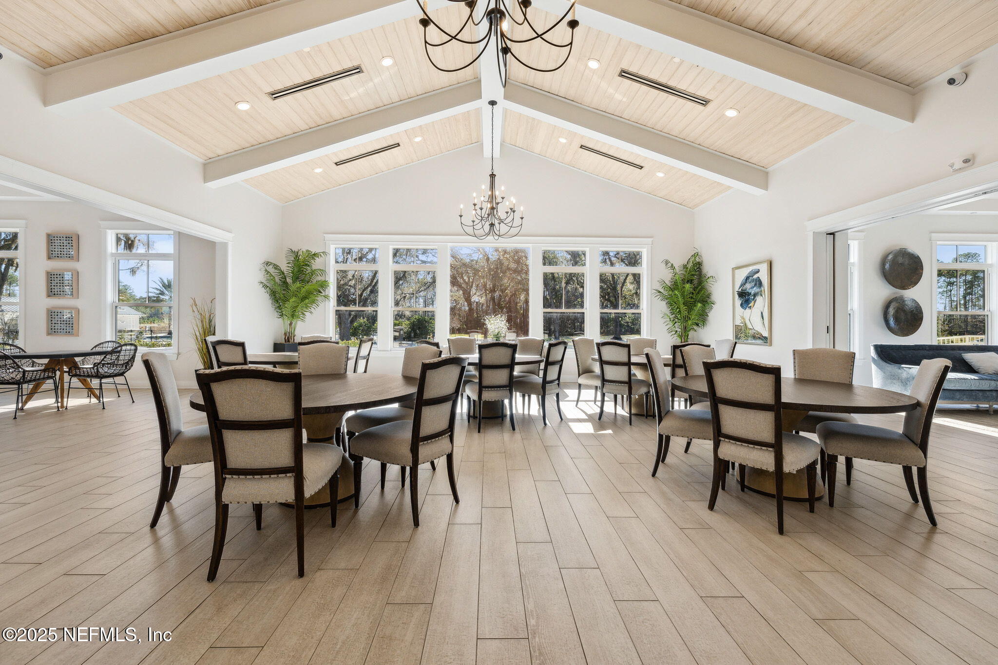 100 Red Barn Road St. Augustine, FL 32092 - Photo 80 of 86 a dining room with wooden floor a chandelier a wooden table and chairs