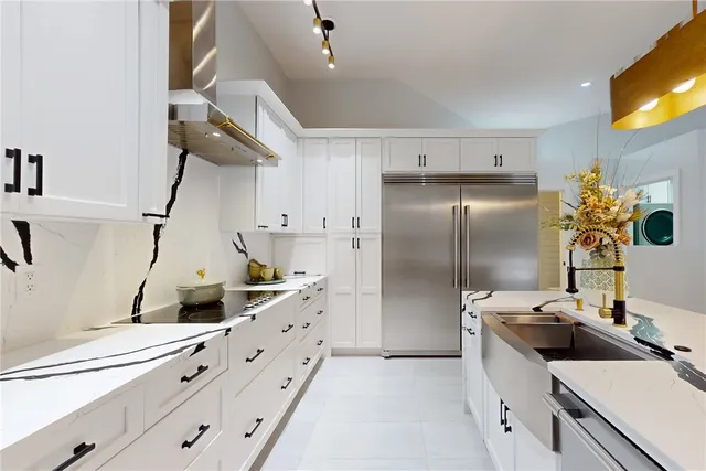 a kitchen with granite countertop a sink stainless steel appliances and cabinets