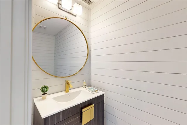 a bathroom with a sink vanity and a mirror