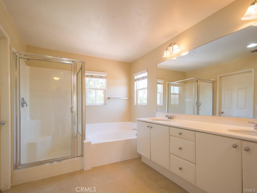 7 Silvermaple Irvine, CA 92618 - Photo 12 of 21 a spacious bathroom with a tub sink shower and mirror