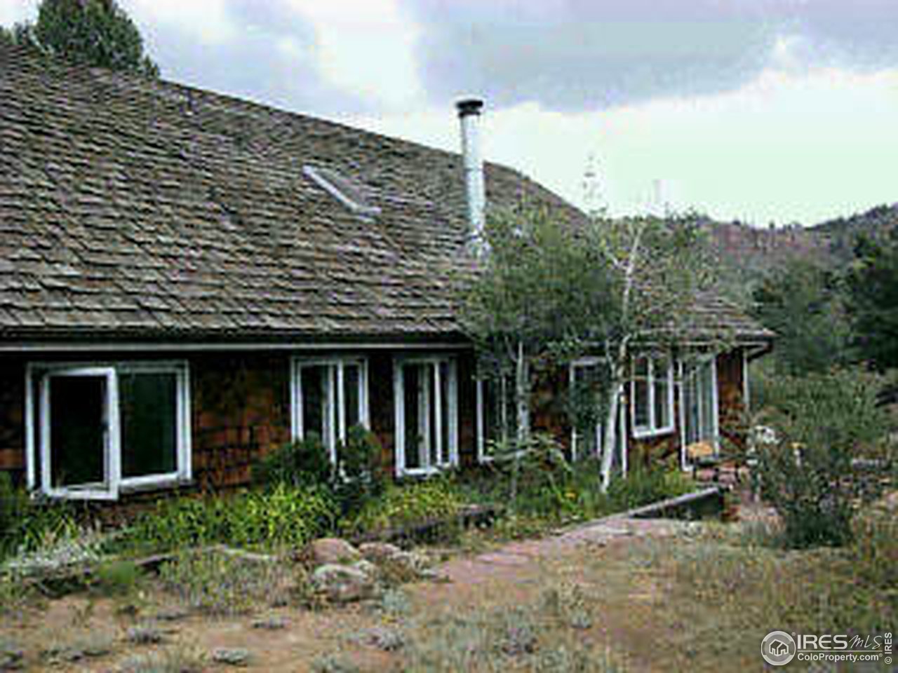 117 Apple Ridge Road Lyons, CO 80540 - Photo 11 of 11 a front view of a house with a garden