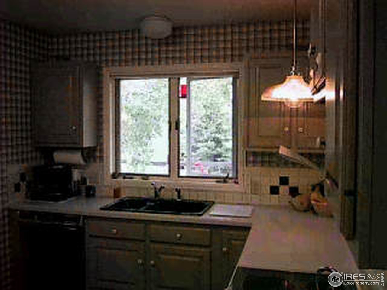 117 Apple Ridge Road Lyons, CO 80540 - Photo 9 of 11 a kitchen with a sink a window and cabinets